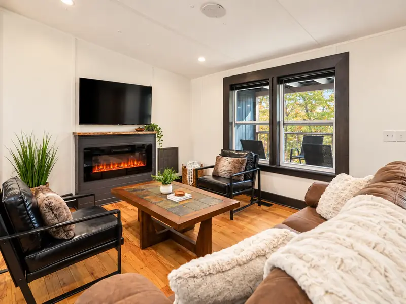 Open-concept living room with electric fireplace at Casita on the Ridge in Blue Ridge, Georgia