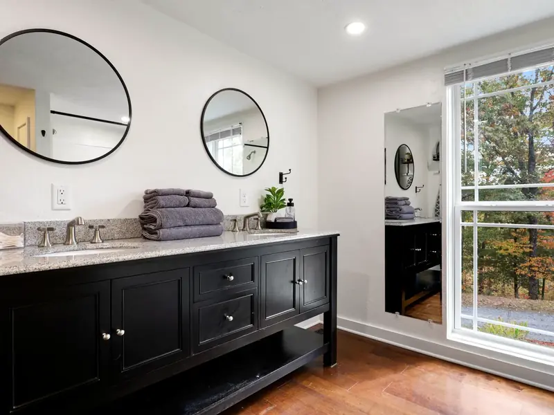 Primary bathroom double vanity with wooded views at Casita on the Ridge in Blue Ridge, Georgia