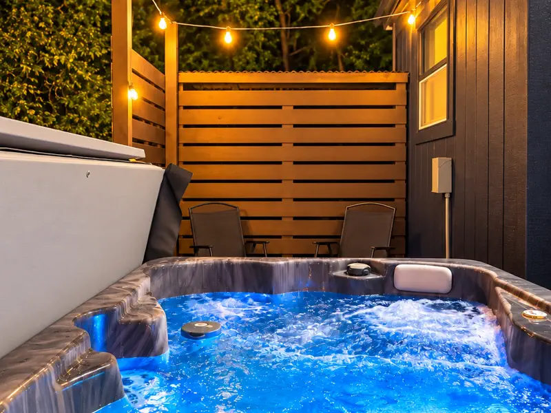 Private hot tub under string lights at Tiny on the Ridge in Blue Ridge, Georgia